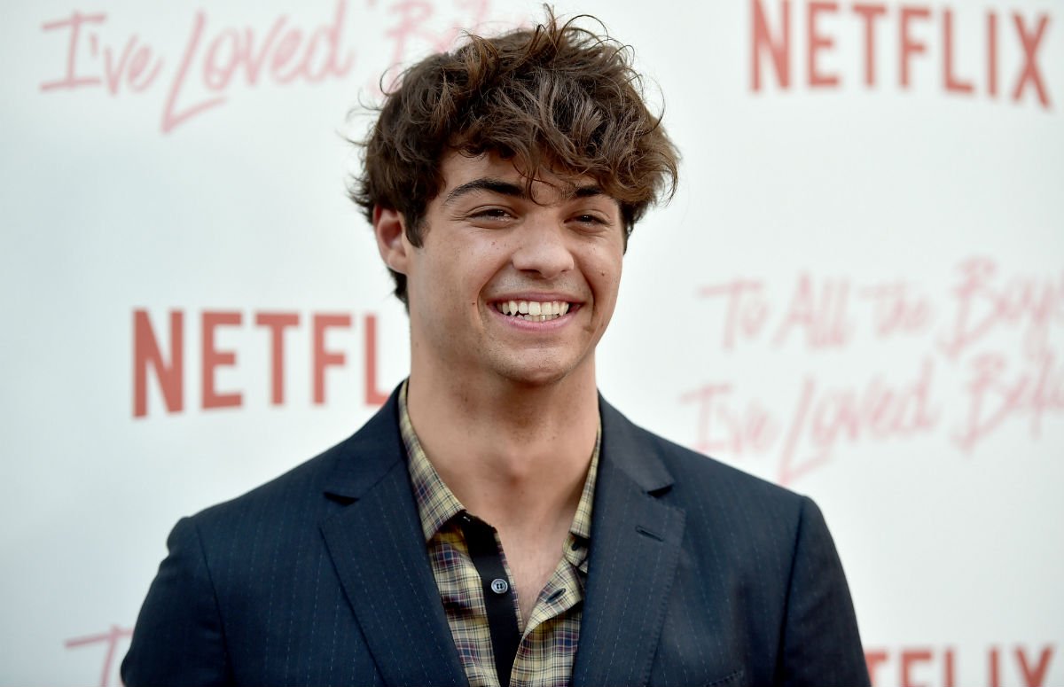 Noah Centineo in a blue suit jacket on the red carpet