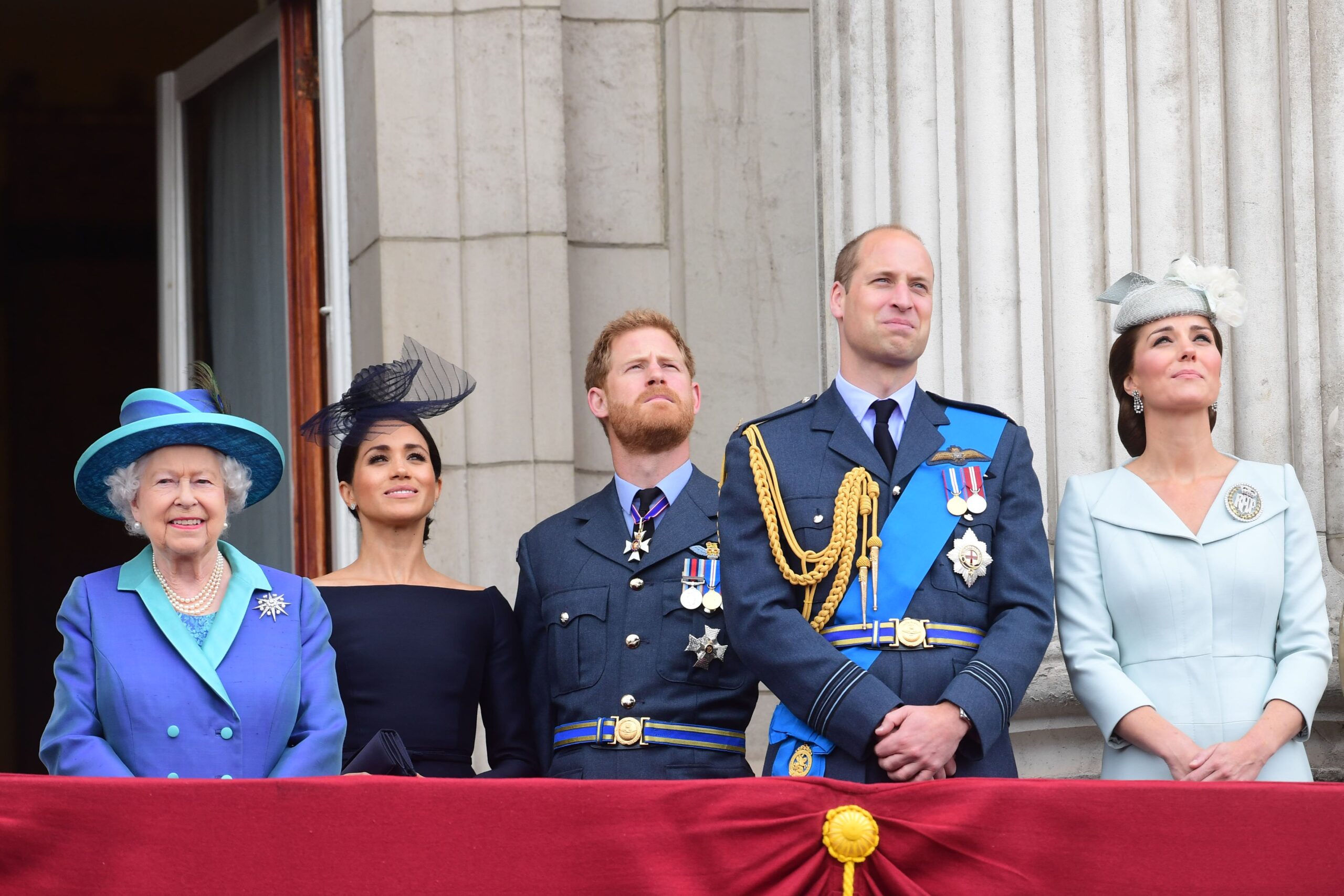 Royal family standing on balcony.