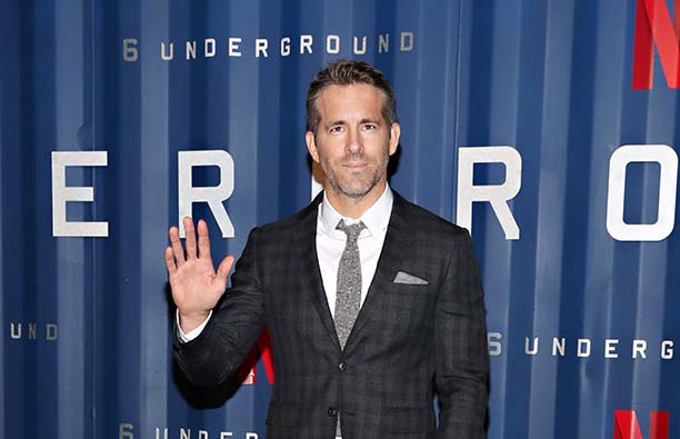 Ryan Reynolds in a dark suit at the premiere of Six Underground