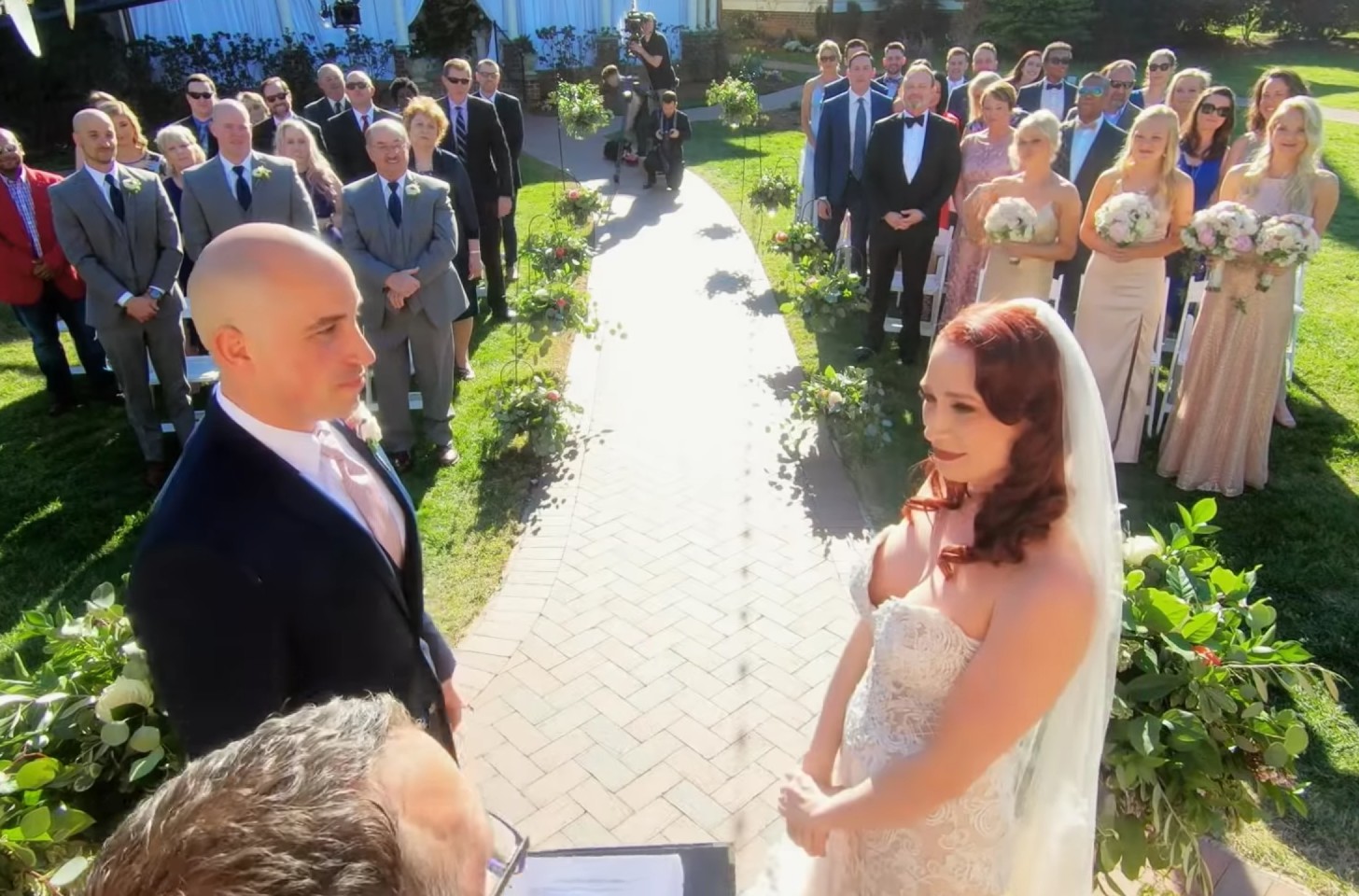 Elizabeth and Jamie from 'Married At First Sight" exchanging their vows in front of a crowd.