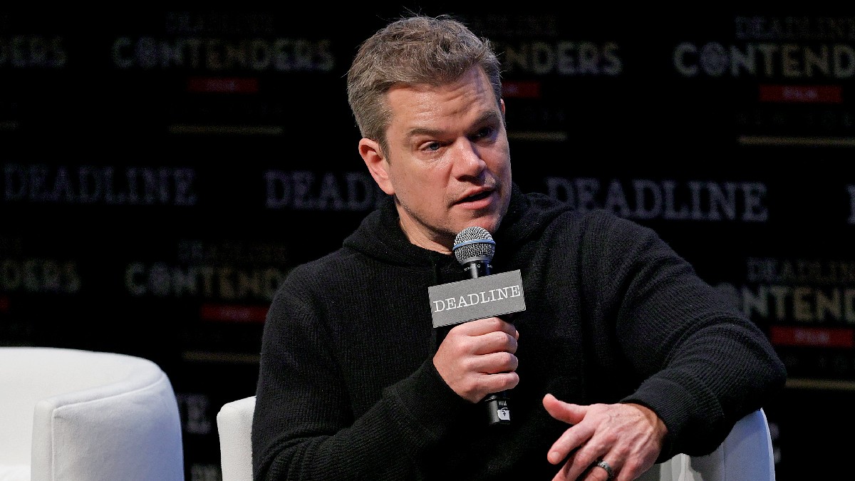 Matt Damon wears a black sweater onstage as he makes remarks
