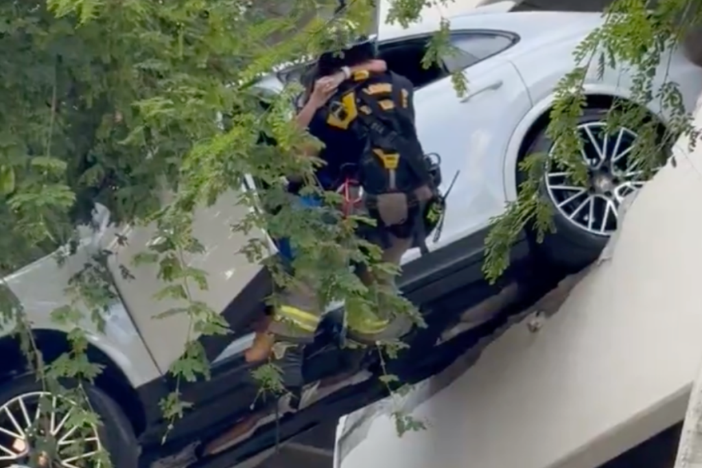 woman-crashes-through-parking-garage-suv-left-hanging-from-3rd-story-in-video