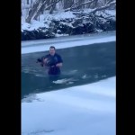 man-jumps-into-frigid-water-to-save-helpless-dog-in-wild-video